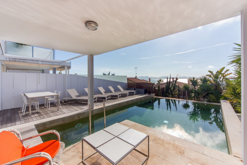 Covered terrace with pool views