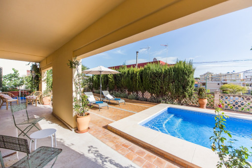 Covered terrace with pool views