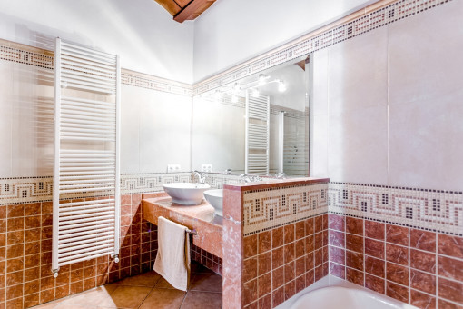 Modern bathroom with bathub and red tiles