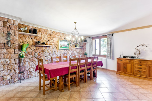 Country-style dining area with stone-wall