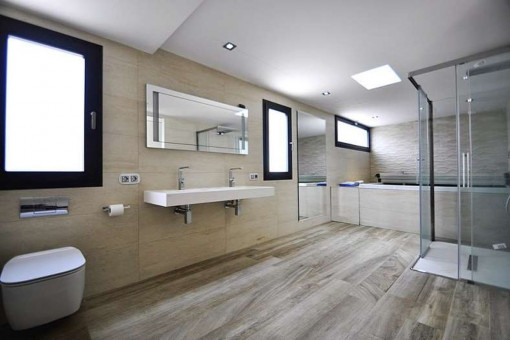 Capacious bathroom with comfortable bathtub and shower