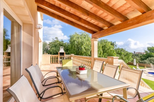 Covered terrace with seating and barbecue area