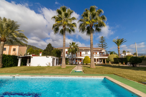 Sunny pool area with palm trees