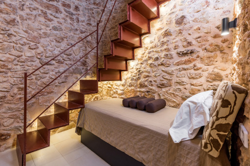 Bedroom with authentic stone wall