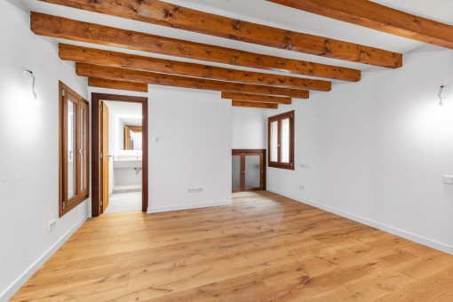 Beautiful bedroom with wooden ceiling beams