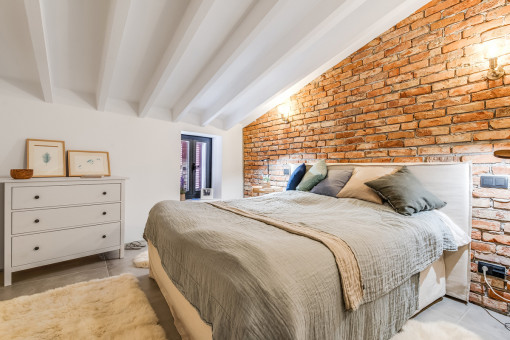 Cosy double bedroom with stone wall