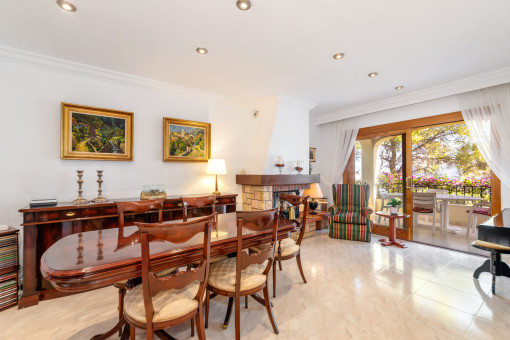 Dining area with fireplace and access to a terrace