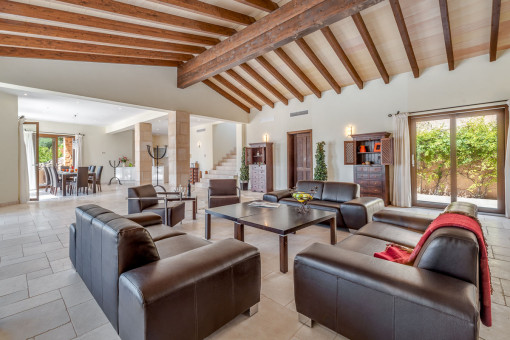 Open-plan living area with wooden celing beams